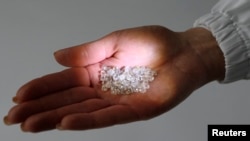 RUSSIA - An employee shows rough diamonds at a sorting center, owned by Alrosa company in Moscow, October 18, 2013.