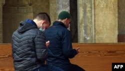 Bosnia-Herzegovina - Bosnian Muslim men pray in front of Sarajevo's central "Gazi-Husref Bey's" mosque, on May 6, 2020