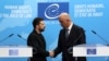 Ukrainian President Volodymyr Zelenskyy and Council of Europe Secretary-General Alain Berset shake hands after the signing of an agreement for establishing a special tribunal to try top officials responsible for Russia's invasion of Ukraine. 